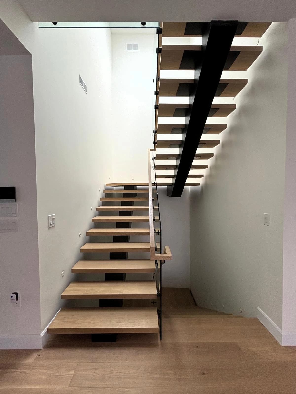 Custom stair treads and matching hardwood stair parts fabricated from customer-provided flooring