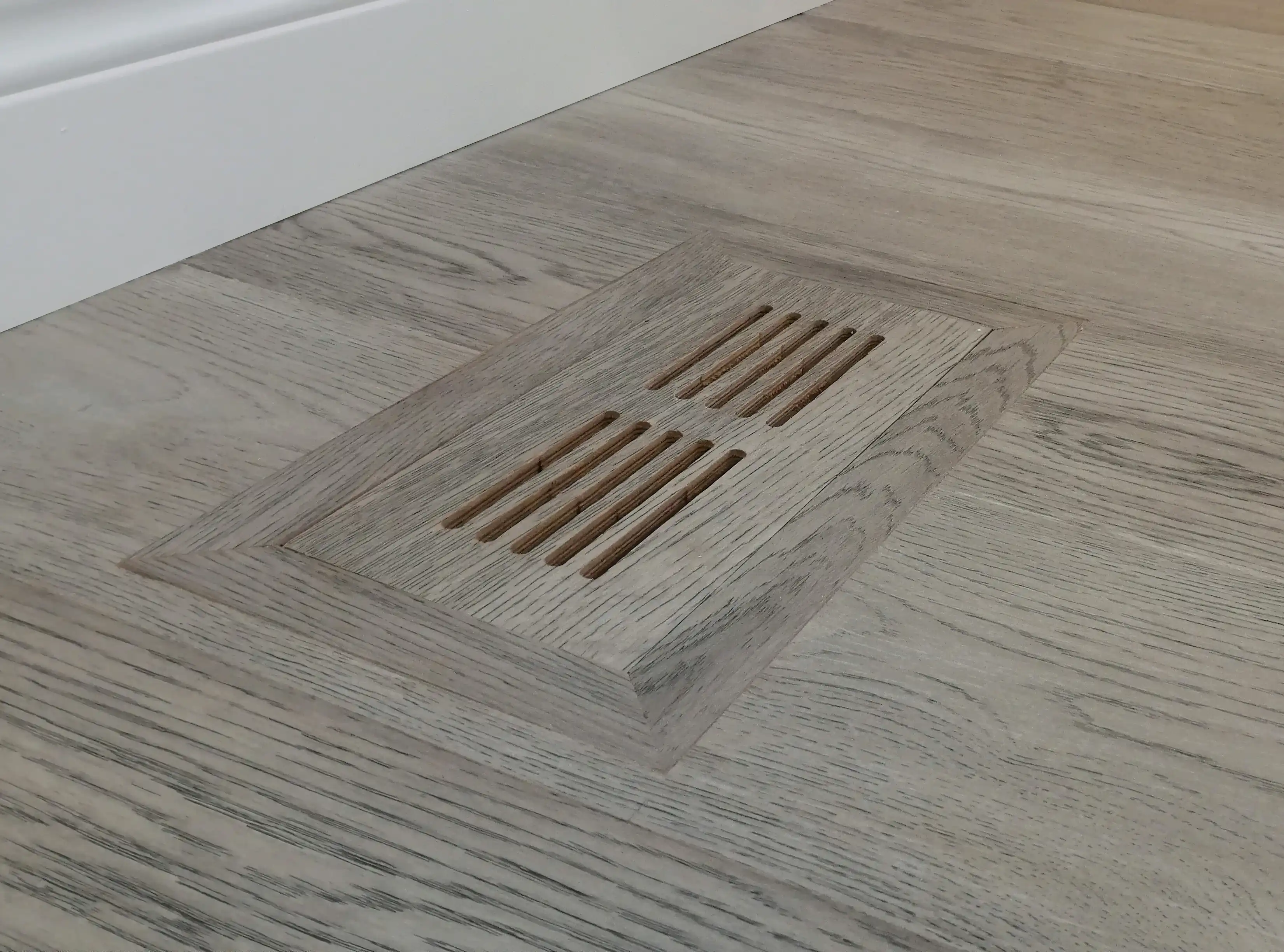 Custom flush mount wood vent cover made to match the surrounding floor